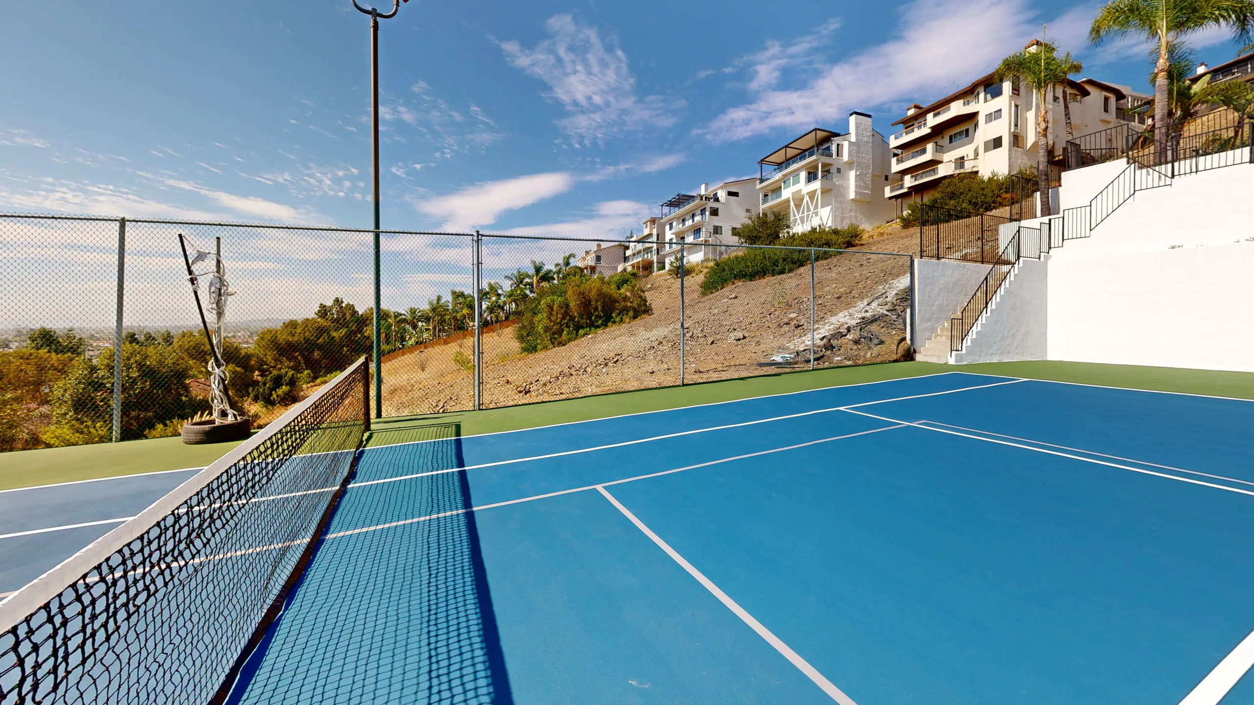 Across the new net on the resurfaced court
