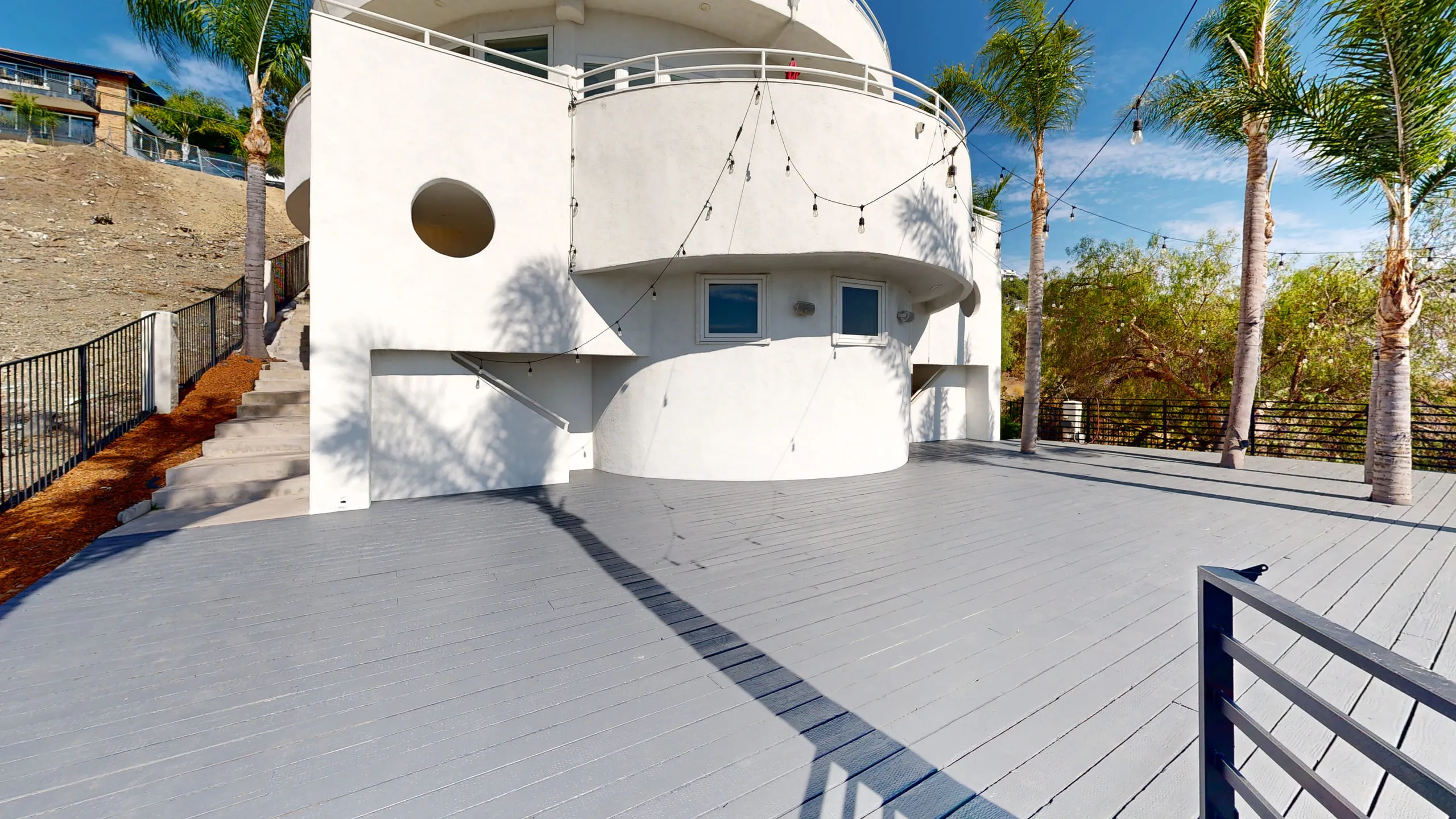 The resurfaced upper deck wrapping the curved tower, strung with lights