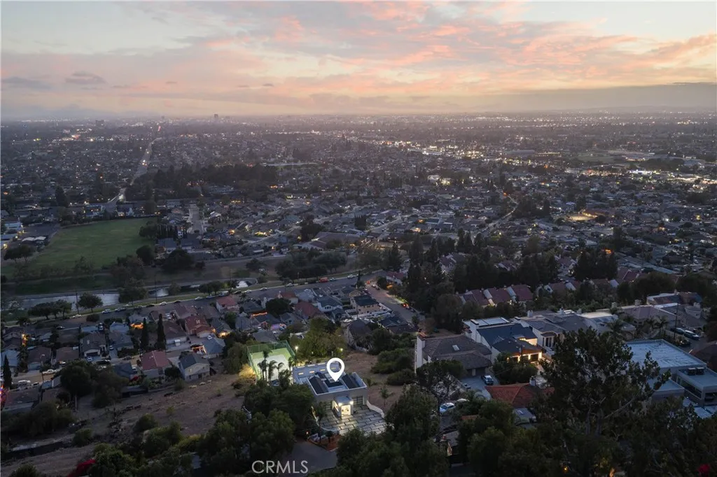 Aerial at dusk — city lights below