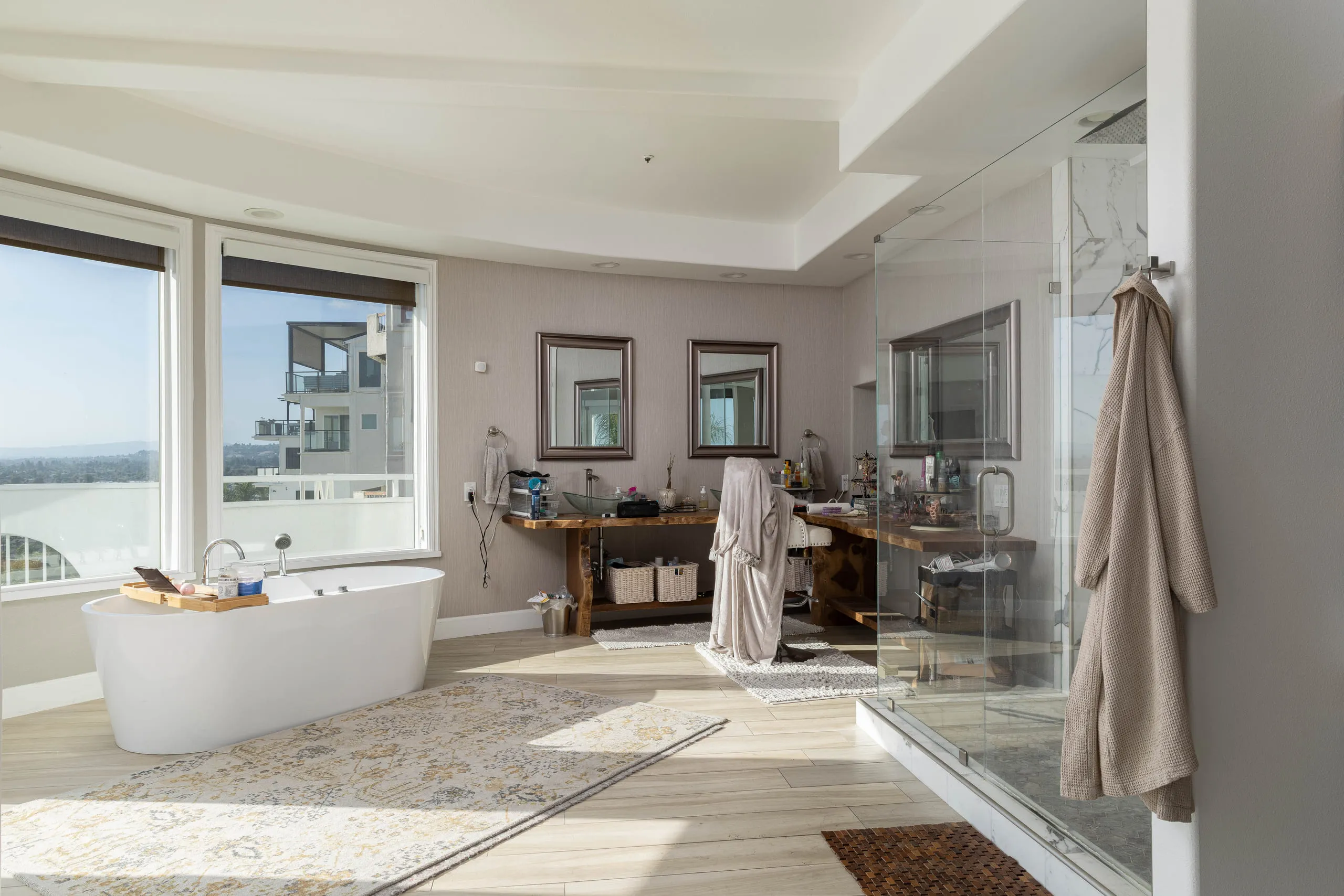 Primary bath with a freestanding tub beneath the view windows